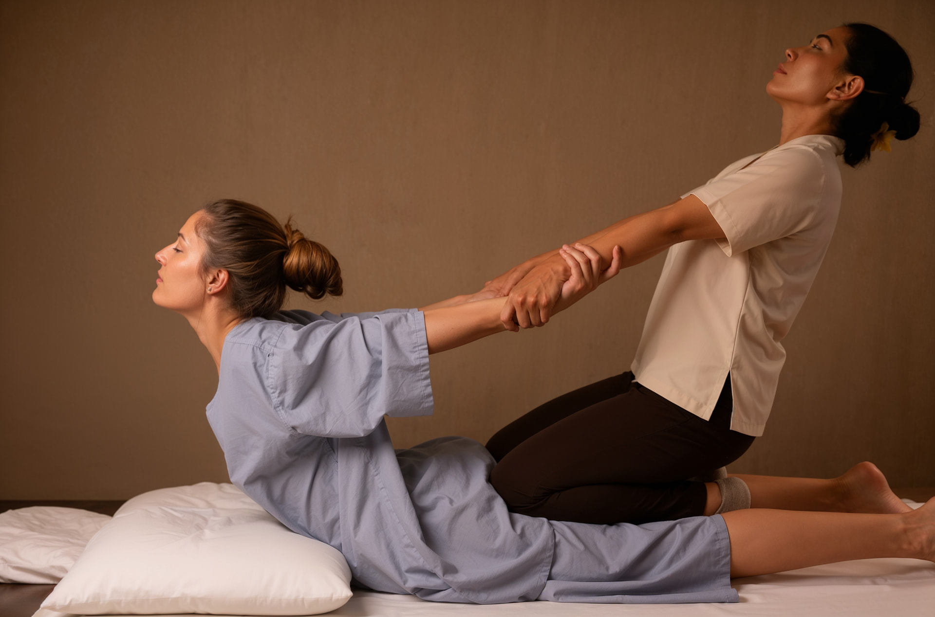 Skilled Thai therapeutic massage stretch in a calm, warm treatment room